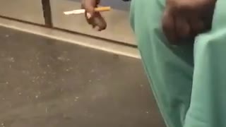Man on subway train falls asleep while smoking cigarette