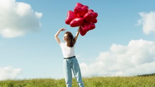Young Woman Posing with Heart Shaped Balloons