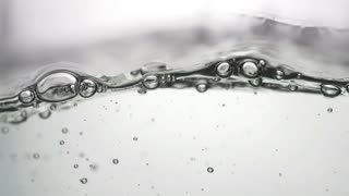 Bubbling water with small bubbles with slow motion