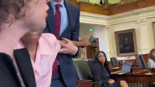 Trans activist physically blocking Texas Senate's sergeant from taking the mic from a trans-identified male testifying against a ban on drag shows for children