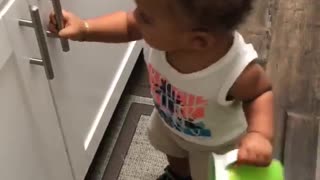 Frustrated Toddler Tries to Open Cabinet