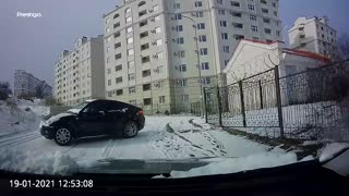 Quick Thinking Driver Reverses Away from Sliding Car