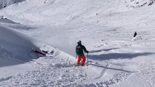 Jerry skier jumps from a cliff a skis into a snow bank