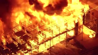 Crews battle commercial yard fire in California