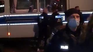 Police beat a woman following the arrest at a protest against Covid restrictions in Berlin