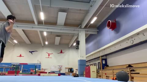 Guy does flips on gymnastics tumbling mat, falls, and lands on shoulder