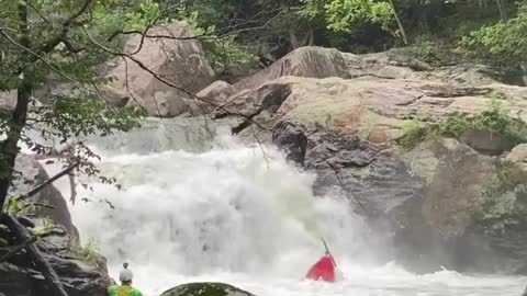 Kayaker performs complete flip while going over waterfall edge