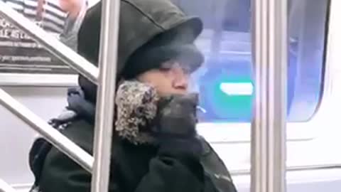 Woman smokes on subway train