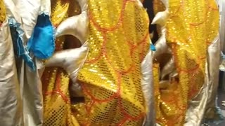 People carrying gold dragon costume in train