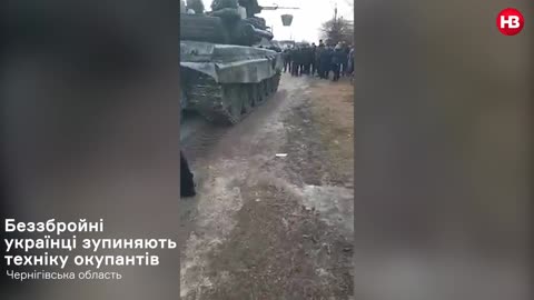 The Ukrainian Townspeople of Koryukivka Block Russian Tanks