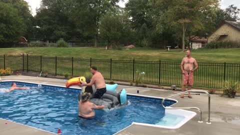 Man jumps into pool, kicks football, and flips over inflatable toucan floaty