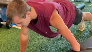One-handed basketball player demonstrates adaptive pushup workout