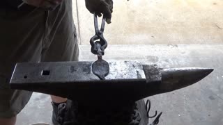 Forging a railroad spike candlestick