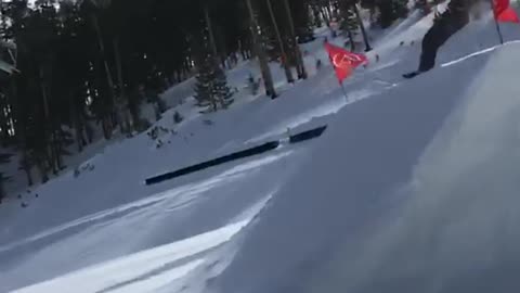 Skier jumps off big ramp and lands on front of skis, falls down slope