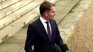 Macron holds umbrella for Slovak leader