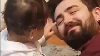 Funny baby playing with daddy's face