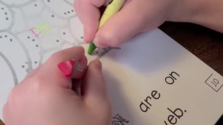 Kindergartner coloring with two hands