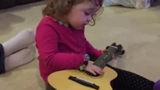 Brett Playing with her guitar