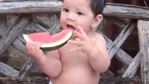Baby eating watermelon strange style