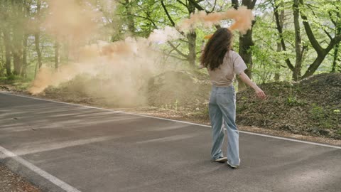 A Woman Turning Around while Holding a Smoke Bomb