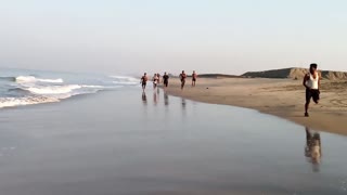 People Running Along The Shore