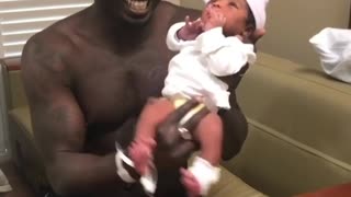 Dad dances with his 2-day-old baby daughter