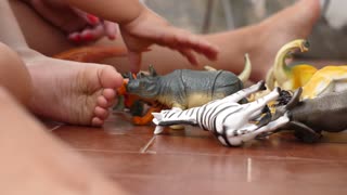 Baby playing with animal toys