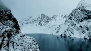 Snowy mountains and lake in winter