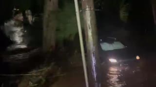 Driver escapes through window of car on flooded road
