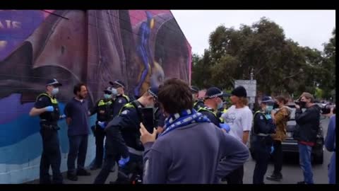 20 Melbourne police officers arrest an unmasked man walking by himself outside