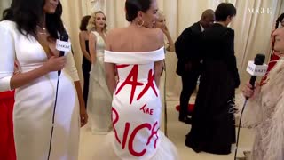 AOC wears a "Tax the Rich" dress to the Met Gala