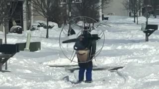 Heavy snow no match for guy wearing skis and high powered fan