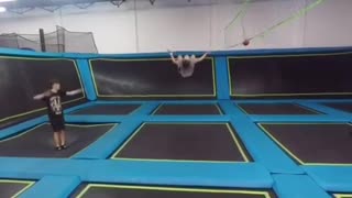 Girl grey shirt black flip trampoline lands on face