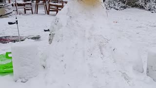 Toddler has funny expression sledding down ice slide