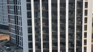 Woman Washes Window from Seventeenth Story