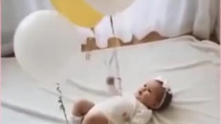 Baby with balloons