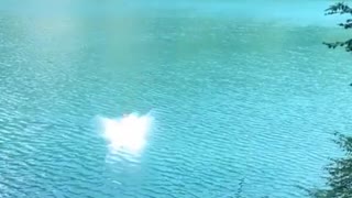 Rope swing backflip fail guy lands on back in blue water