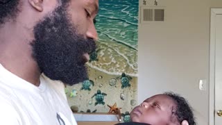 Loving dad sings and dances with his newborn baby