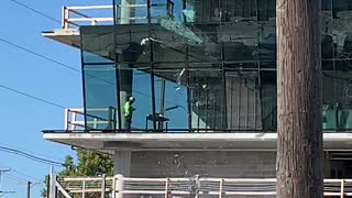 Construction Workers Break Large Glass Window