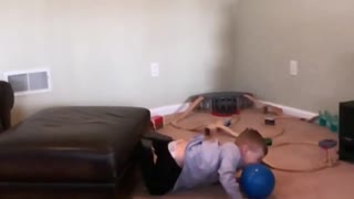 Little boy jumps from couch too ottoman, bounces off, face plant into blue ball and scorpions