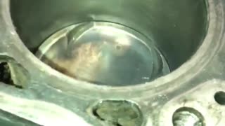 Installing a Piston into an Engine with a Hammer