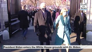 President Biden enters the White House grounds with Dr. Biden