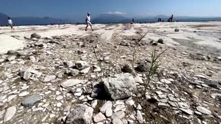 Rocky beach emerges from Lake Garda after drought