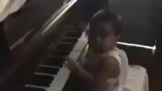 Amazing 1 yr old child playing a piano