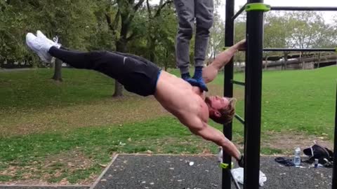 Man shows off insane strength while demonstrating the "human flag"