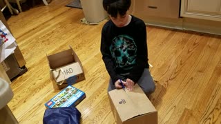 Spencer opening Chanukah Presents 20161224_174309