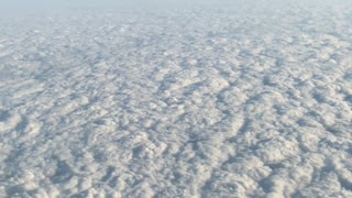 Clouds seen through the window from inside an airplane