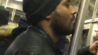 Man black jacket kissing subway pole