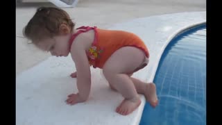 Adorable baby tries to get into the pool