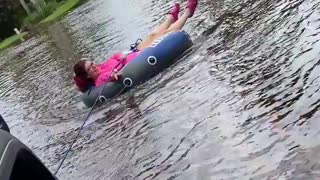 Woman goes tubing in the streets of Florida during Tropical Storm Eta